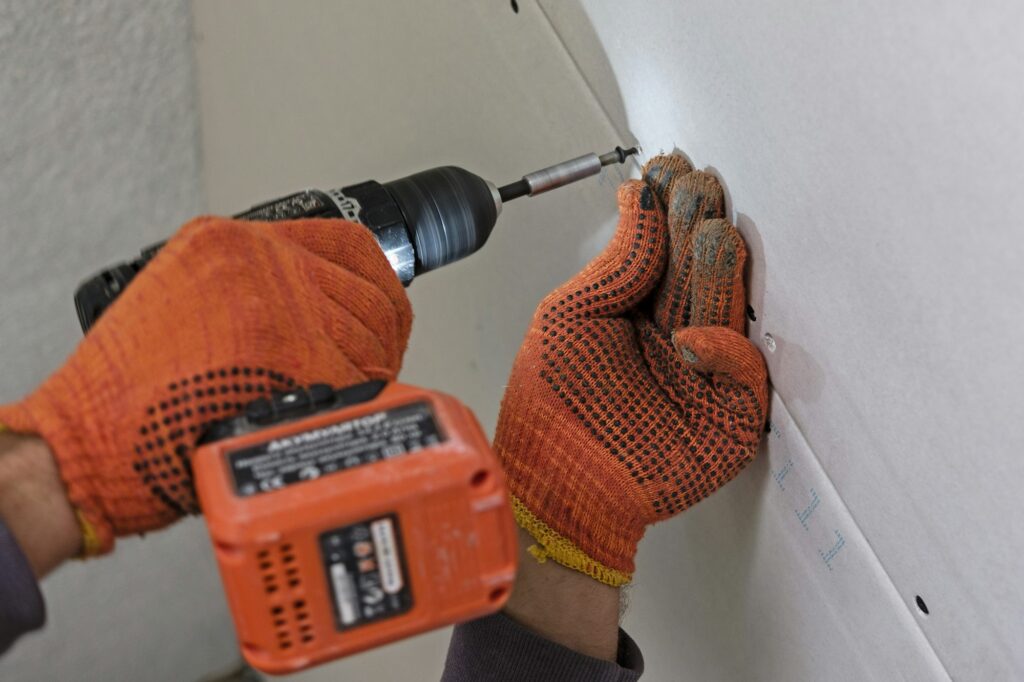 Fastening drywall process in close-up